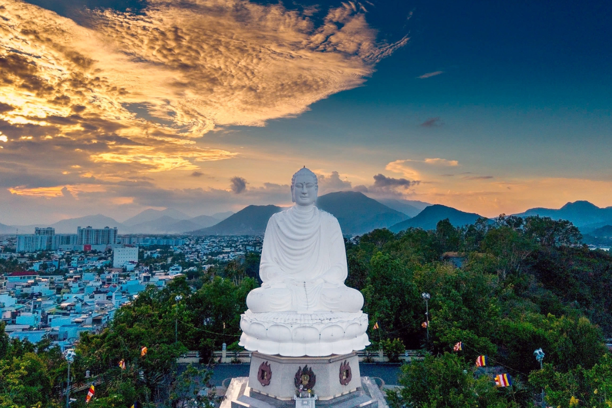 White Gautama Buddha statue on lotus pedestal at the top of Trai Thuy hill, Nha Trang